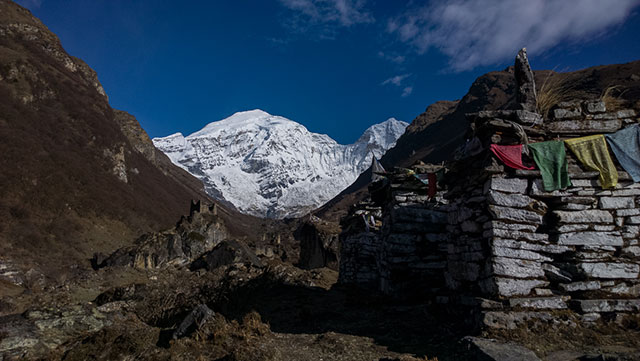 View of Mt Jomolhari from basecamp, marked by a mani wall and a ruin dzong.
